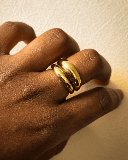 tacked presentation of the Aura Ring Set, featuring one hammered and one smooth gold-plated ring