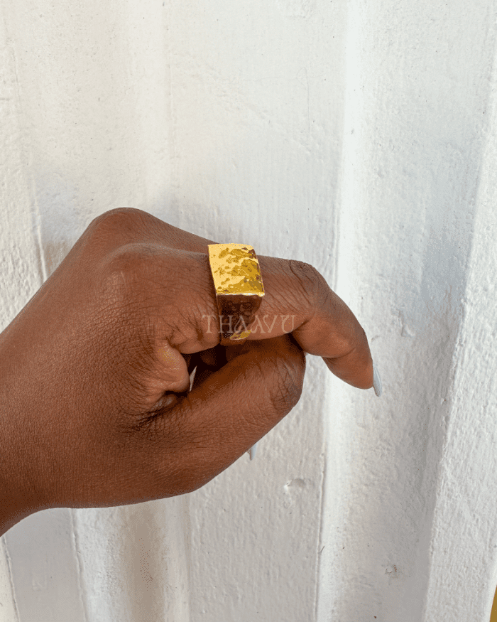 Close-up view of The U Ring, a unisex gold-plated ring with hammered texture.